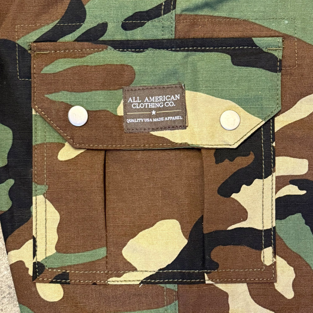 Camouflage jacket with a visible brand label on a camouflage background